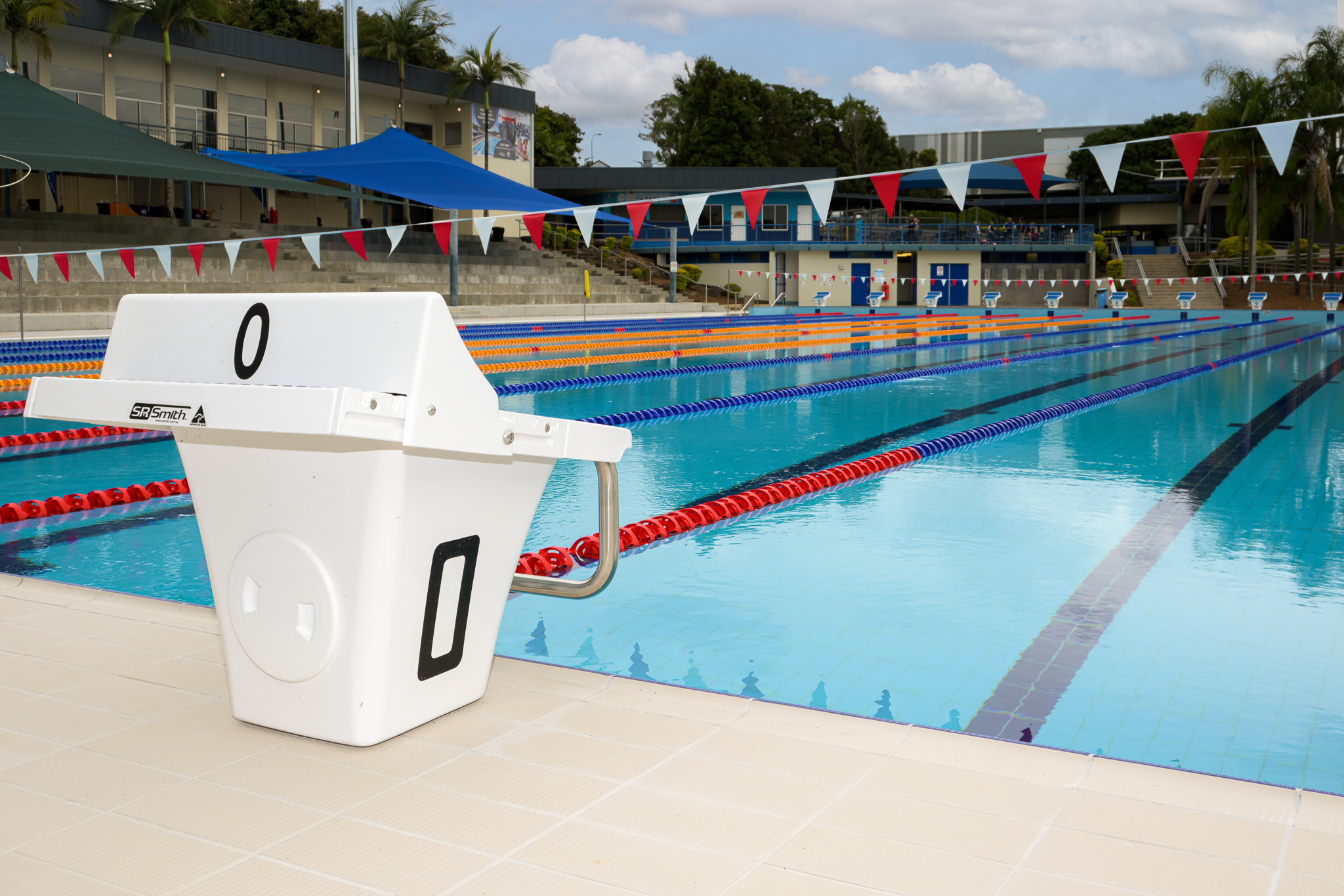 0 numbered diving block left of frame in front of outdoor pool at Logan North Aquatic Centre