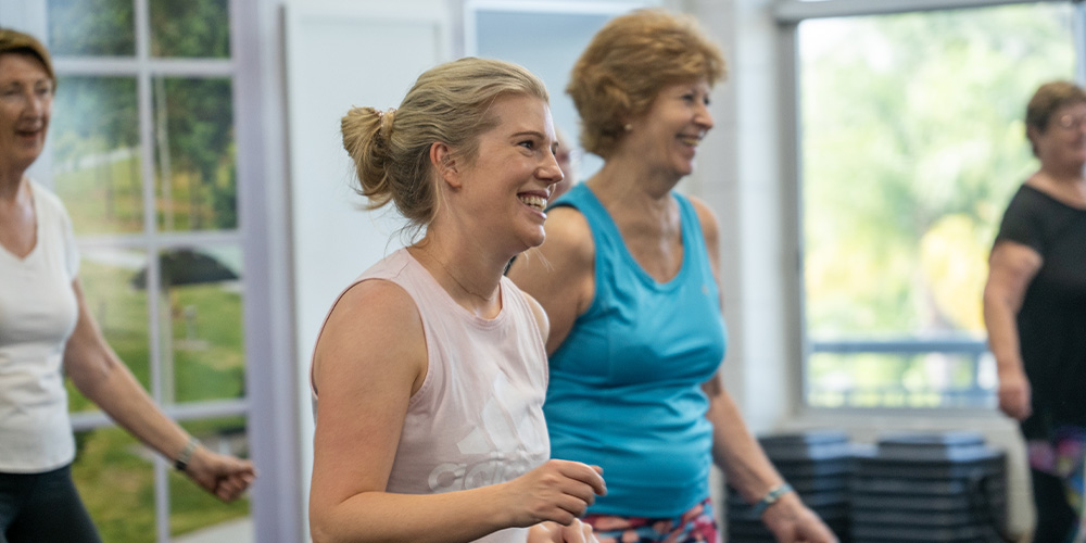 Ladies smiling while moving during a Konga Group Fitness Class